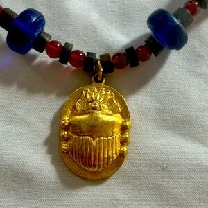 Gold Scarab Pendant Necklace with Blue and Red glass beads.